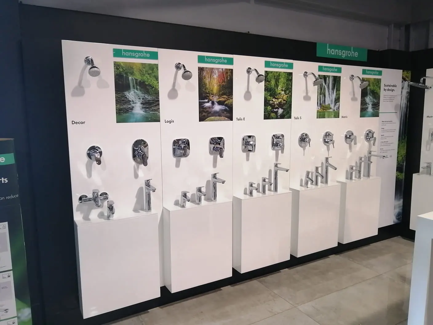 Showroom display of taps and shower fittings on white plinths