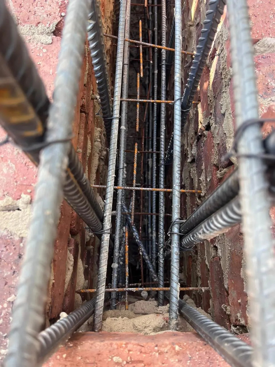 Reinforcing steel set inside a brick column before concrete is poured