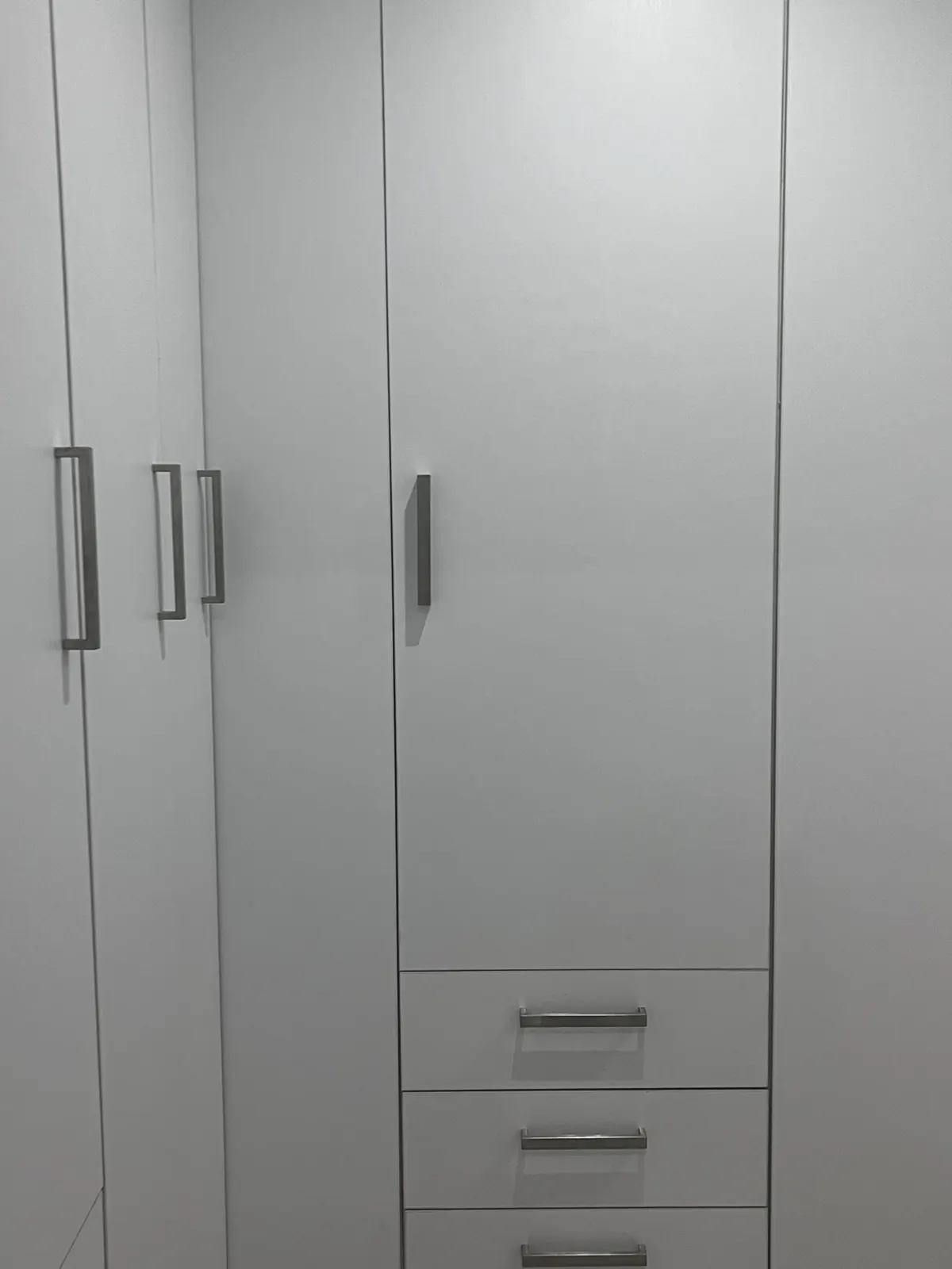 White built-in wardrobe with bar handles