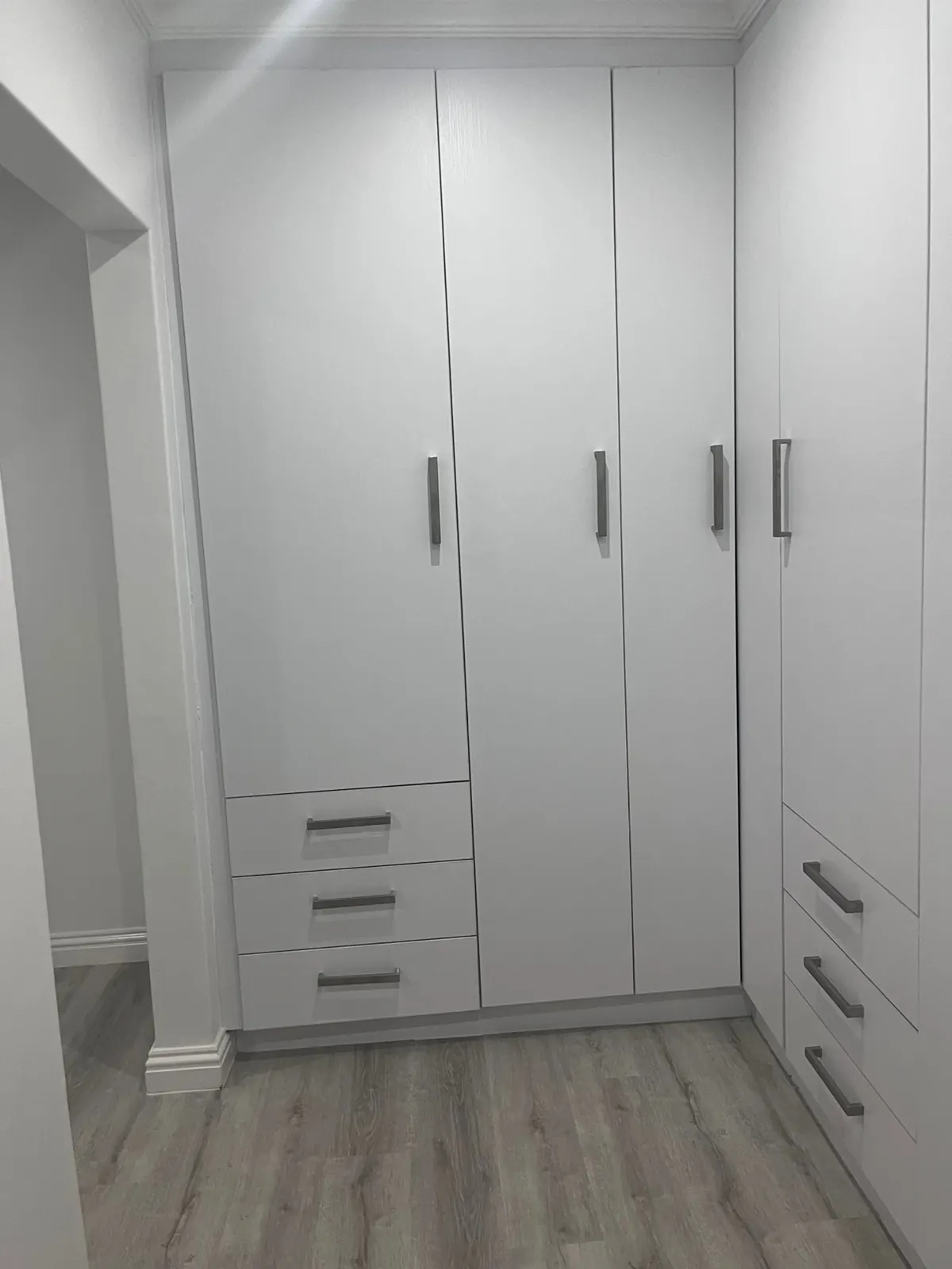 White wardrobes with a three-drawer unit