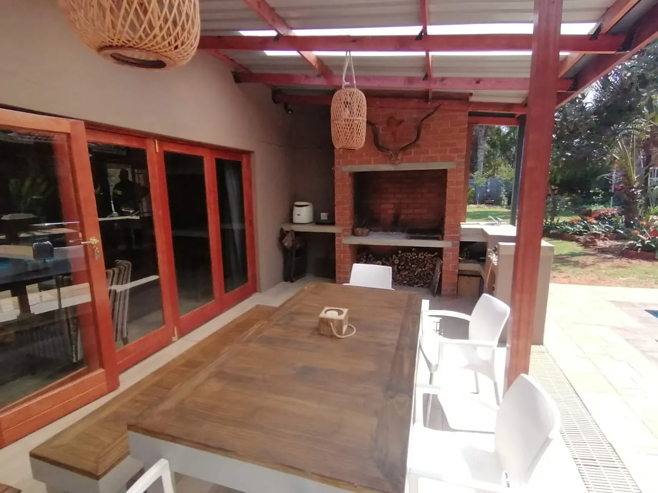 Brick braai and timber folding doors onto a covered patio