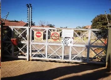 After: the same steel estate gates repaired and repainted grey