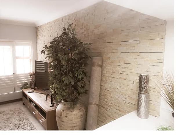Stacked sandstone feature wall cladding wrapping a lounge corner